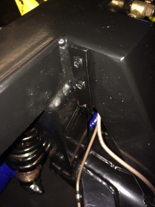 Small hammerite painted bracket fixed using two self tappers.